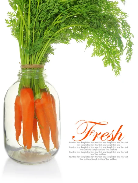 Fresh carrots with leaves in glass jar isolated — Stock Photo, Image