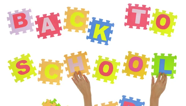 Hands forming phrase "Back to school" with jigsaw puzzle — Stock Photo, Image