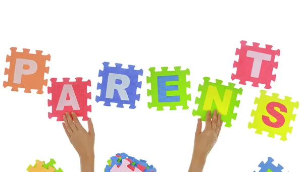 Hands forming word "Parents" with jigsaw puzzle pieces isolated — Stock Photo, Image