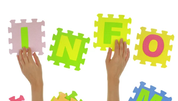 Hands forming word "info" with jigsaw puzzle pieces isolated — Stock Photo, Image