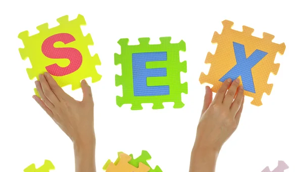 Hands forming word "Sex" with jigsaw puzzle pieces isolated — Stock Photo, Image