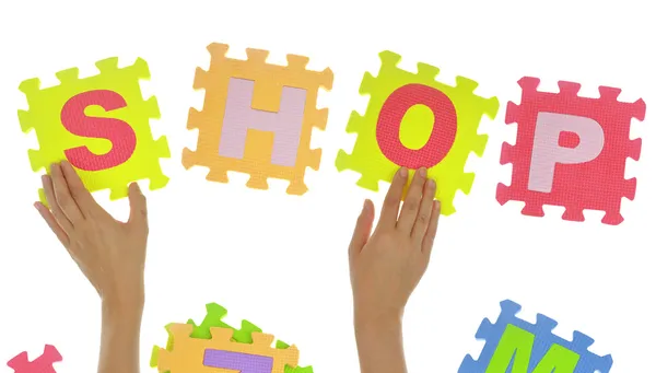 Hands forming word "Shop" with jigsaw puzzle pieces isolated — Stock Photo, Image