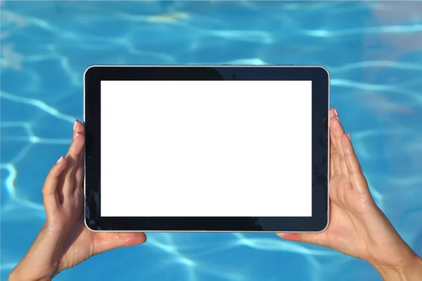 Woman hand holding tablet computer in the pool — Stock Photo, Image