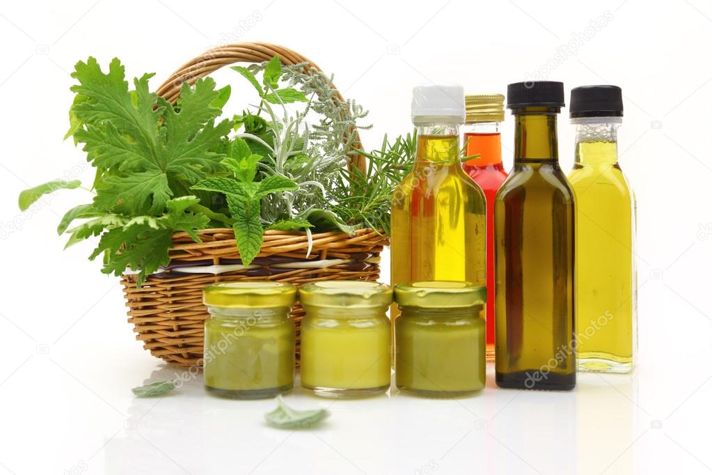 Fresh herbs in wicker basket and natural cosmetics 