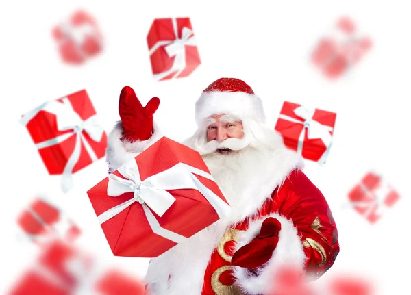 Santa Claus standing and doing magic. Gift boxes falling down ar — Stock Photo, Image
