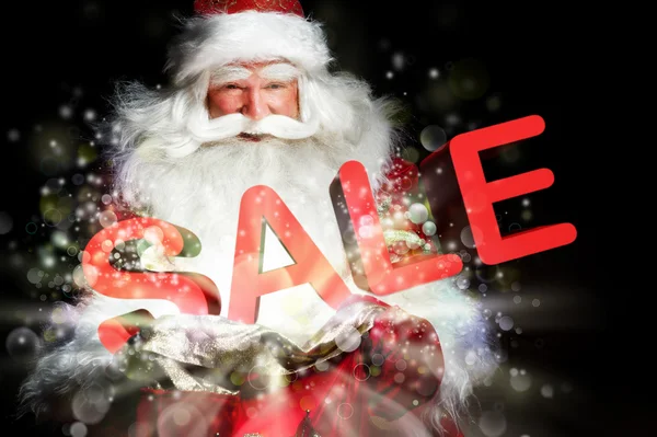 Santa Claus holding his bag and smiling. Lights and sparks are f — Stock Photo, Image