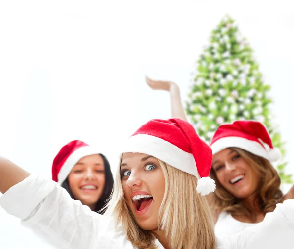 Group of three happy pretty girls are celebrating christmas and Stock Picture