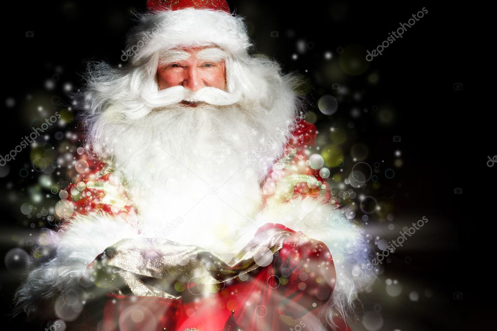 Santa sitting at the Christmas room and looking into the sack