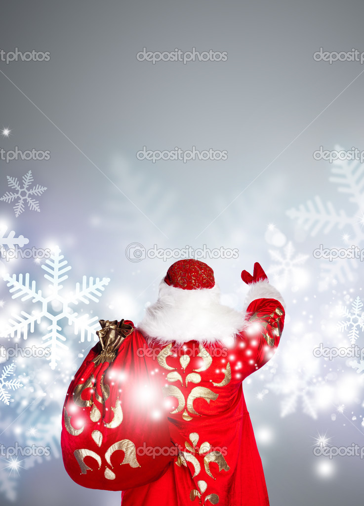Santa Claus is making magic, photo from behind