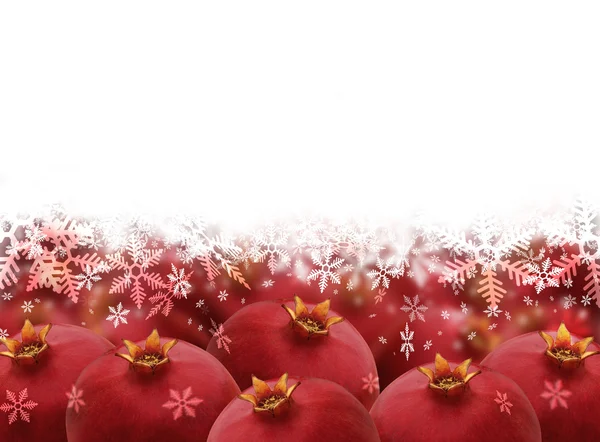 Bright red pomegranates isolated on white background with snowfl — Stock Photo, Image