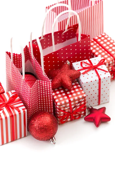Gift boxes with xmas presents wrapped in red paper with ornament — Stock Photo, Image
