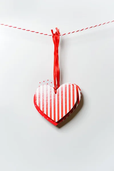 Red textured hearts hanging on white background — Stock Photo, Image