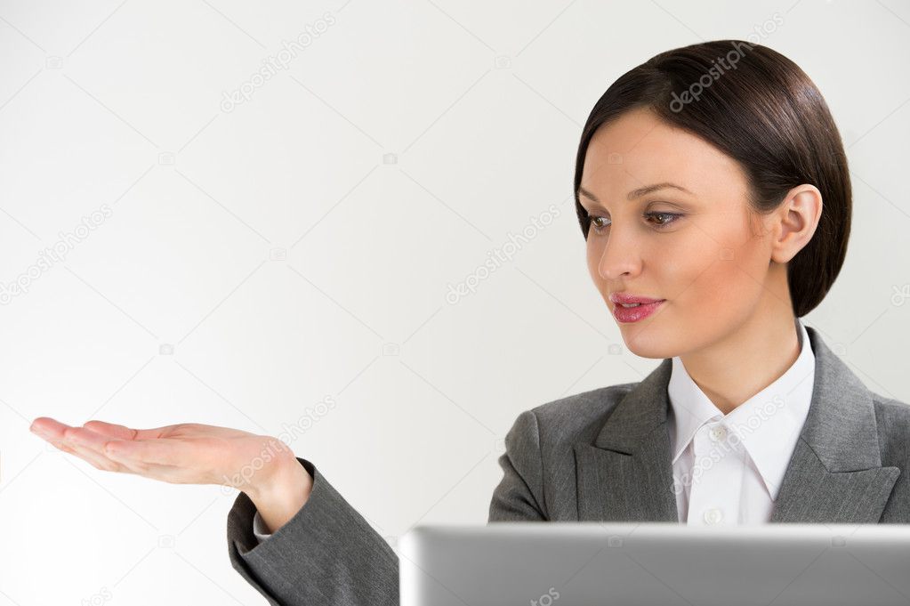 Adult pretty business woman making presentation of new product.