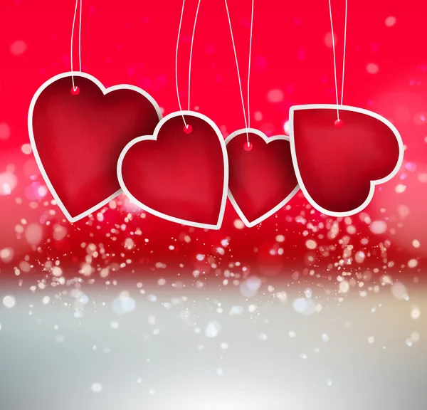 Corazón de San Valentín colgando etiquetas sobre fondo brillante — Foto de Stock