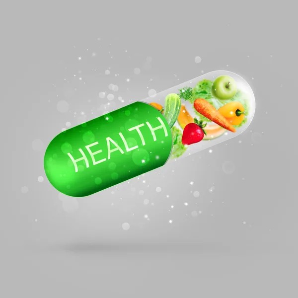 Different fruit and vegetables in capsule - healthy diet or natural vitamins concept — Stock Photo, Image