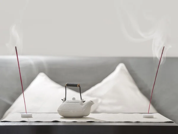 Teapot and incense stick on table at comfortable relaxation loun — Stock Photo, Image