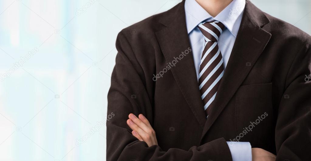 Closeup of torso of confident business man wearing elegant suit