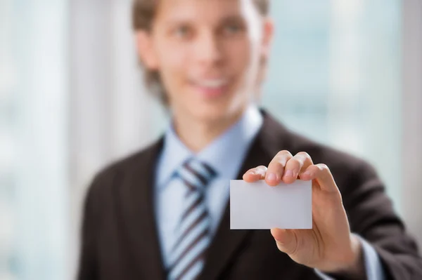 Business man handing a blank business card at his office — Stock Photo, Image