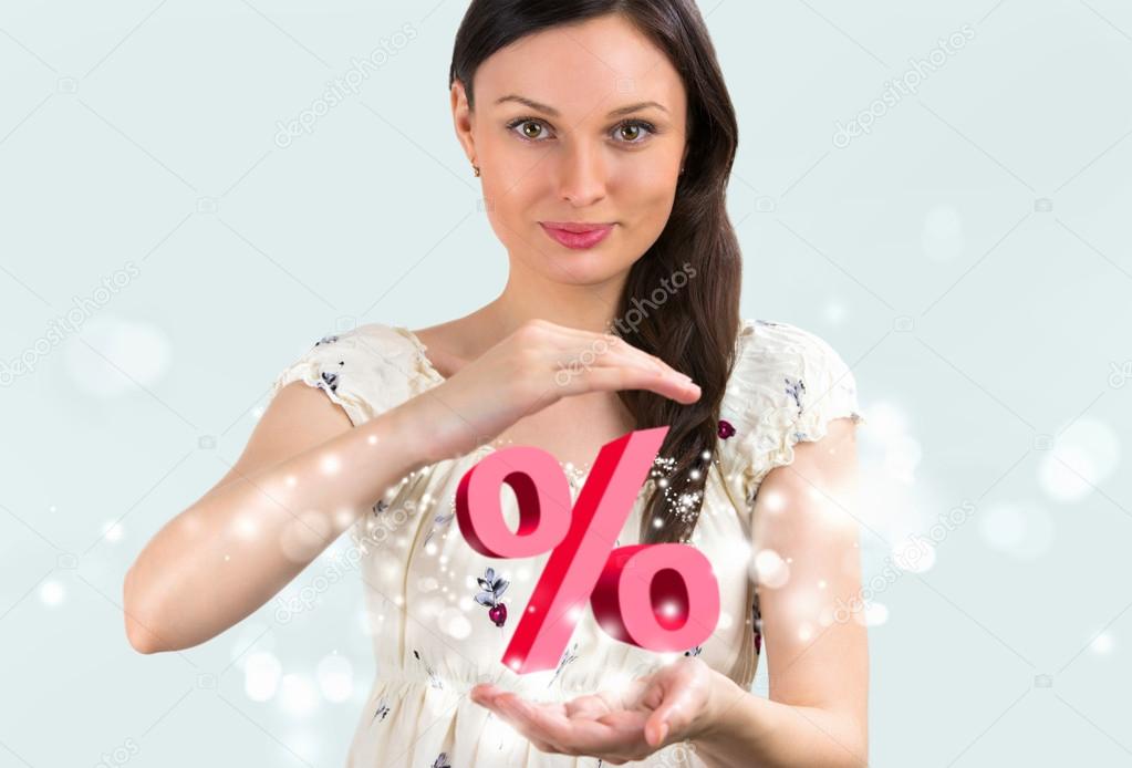 Portrait of young girl holding discount symbol in her arms