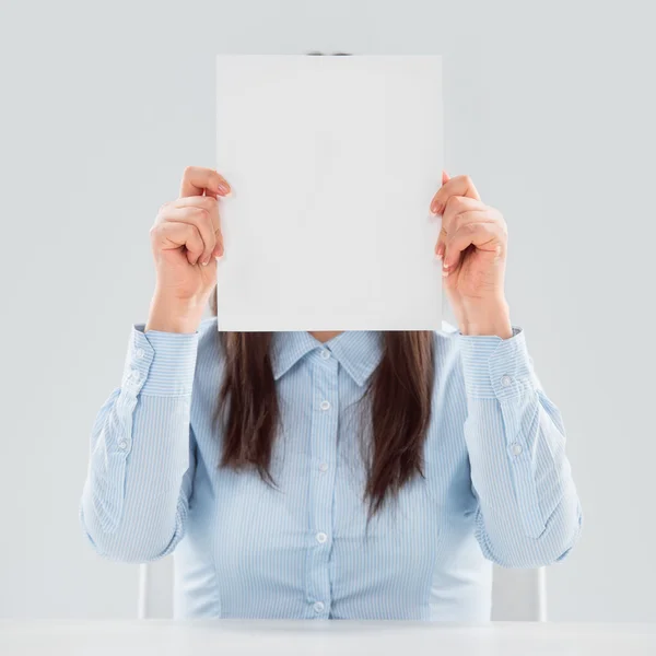 Portrait of business woman holding blank paper sheet — Stok fotoğraf