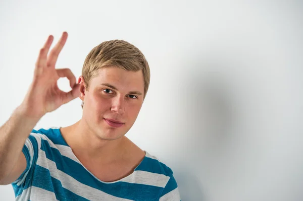 Closeup of good looking young man gesturing okay sign — Stock Photo, Image