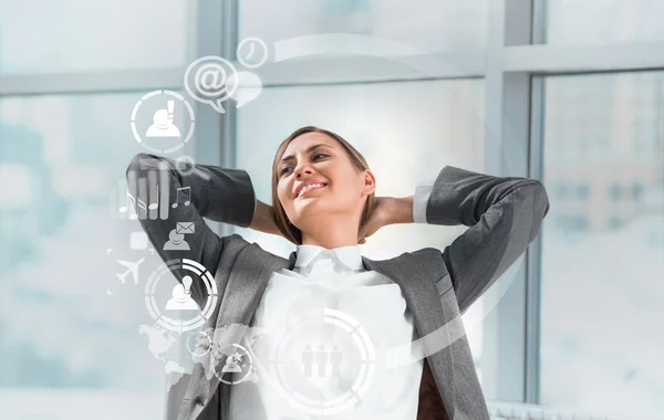 Businesswoman and virtual interface with web and social media icons — Stock Photo, Image