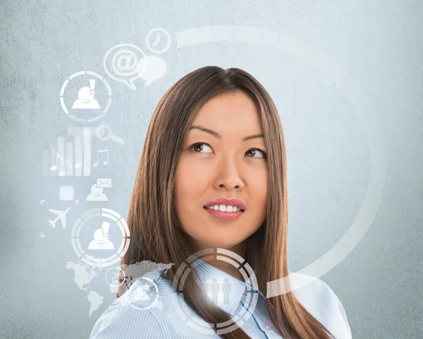 Businesswoman and virtual interface with web and social media icons — Stock Photo, Image