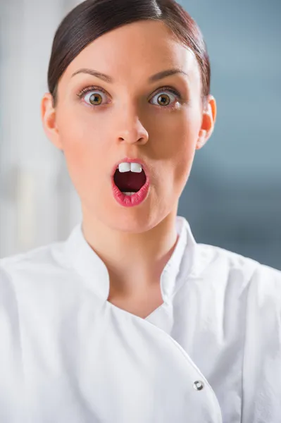 Funny female dentist with chewing gum instead of front teeth. — Stock Photo, Image