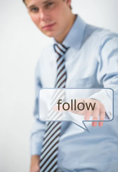 Handsome businessman pressing on follow button — Stock Photo, Image