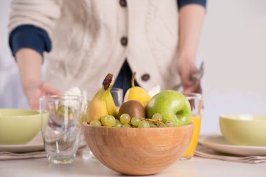 Human hands preparing table for lunch