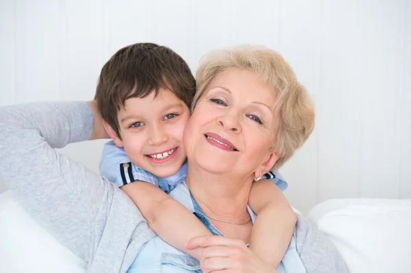 Lovely little boy with his grandmother having fun and happy mome — Stock Photo, Image