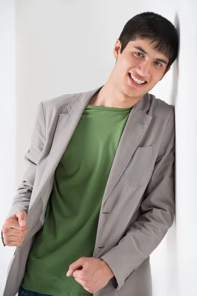 Happy smiling young man leaning — Stock Photo, Image