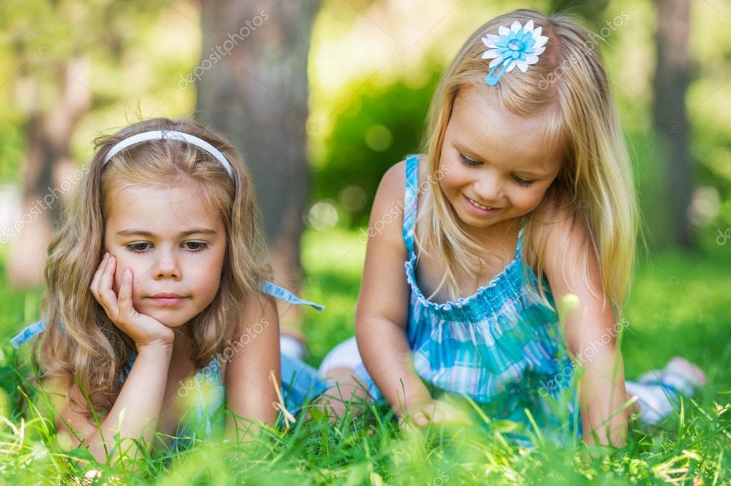 Two little sisters having fun in summer park — Stock Photo © HASLOO ...