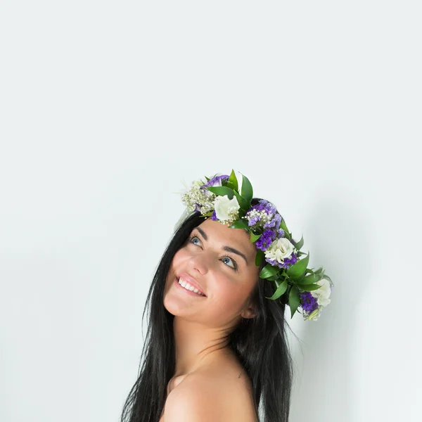 Mooie jonge vrouw met delicate bloemen in haar haren — Stockfoto