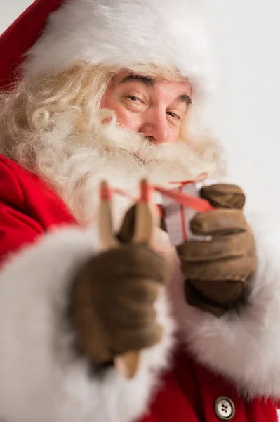 http://st.depositphotos.com/1028979/3106/i/450/depositphotos_31063883-Portrait-of-happy-Santa-Claus-aiming-christmas-gift-with-slingsh.jpg