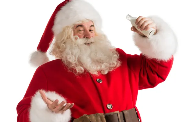 Weihnachtsmann trinkt Milch aus Flasche — Stockfoto