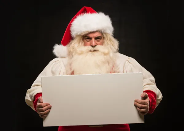 Papai Noel segurando sinal branco em branco — Fotografia de Stock