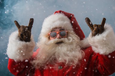 Santa Claus wearing sunglasses dancing outdoors at North Pole