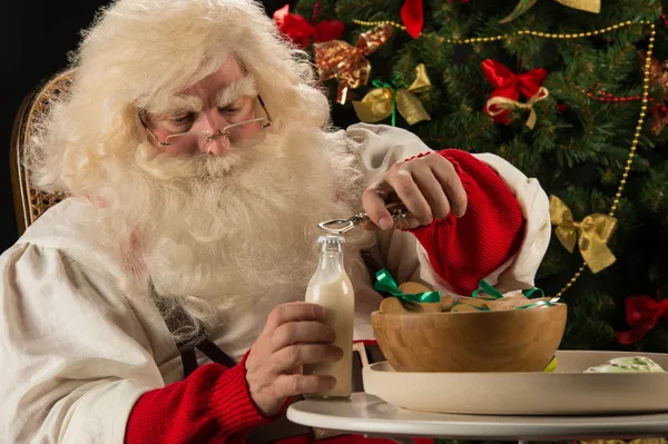 Santa Claus eating cookies — Stock Photo, Image