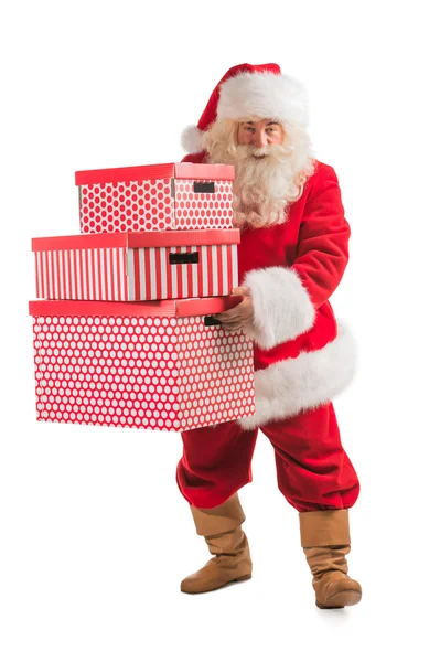 Санта-Клаус несет стопку подарков — стоковое фото