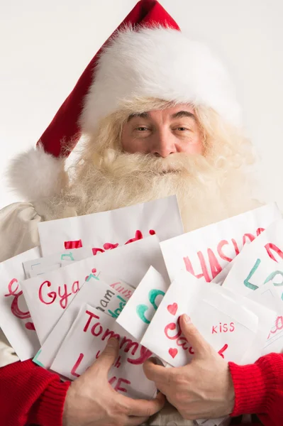 Santa Claus holding heap of letters — Stock Photo, Image