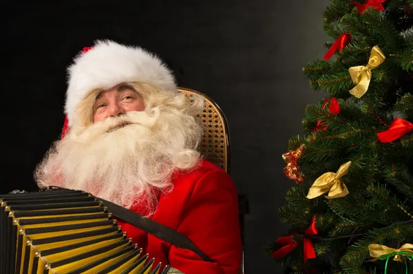 Santa Claus sitting in armchair — Stock Photo, Image