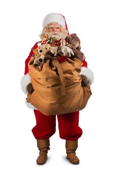 Санта-Клаус несет большую сумку — стоковое фото