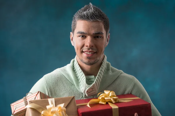 Young man carries a lot of presents — Stock Photo, Image