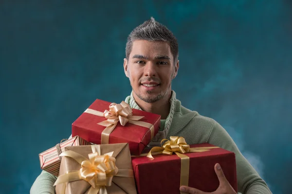 Young man carries a lot of presents — Stock Photo, Image