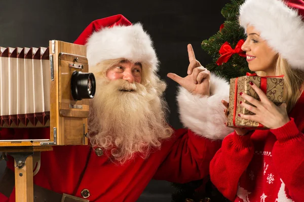 Photo of Santa Claus with his wife taking pictures — Stock Photo, Image