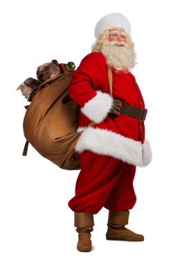 gerçek Noel Baba hediye dolu büyük bir çanta taşıyor