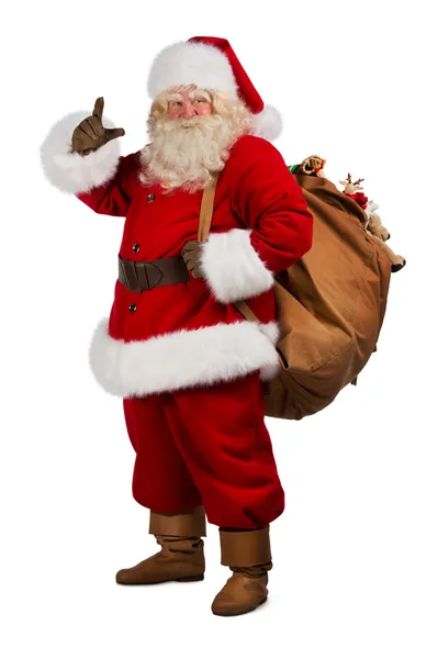 Real Santa Claus llevando una gran bolsa llena de regalos — Foto de Stock