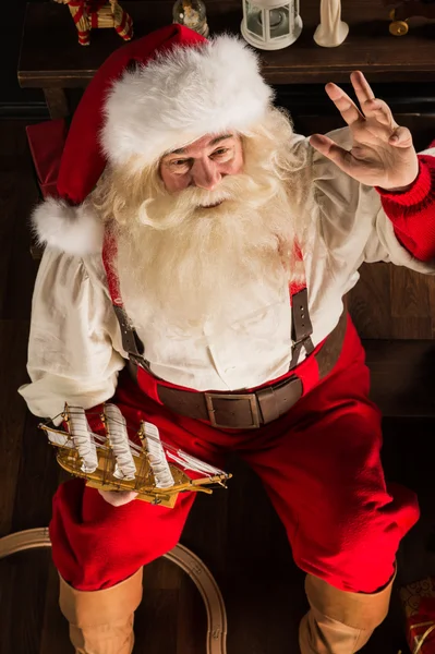 Santa Claus at home playing with new toys near Christmas Tree — Stock Photo, Image