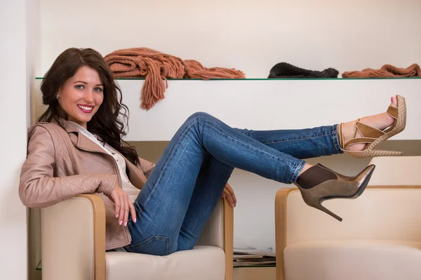 Image of lady trying on several pairs of new shoes in the store — Stock Photo, Image